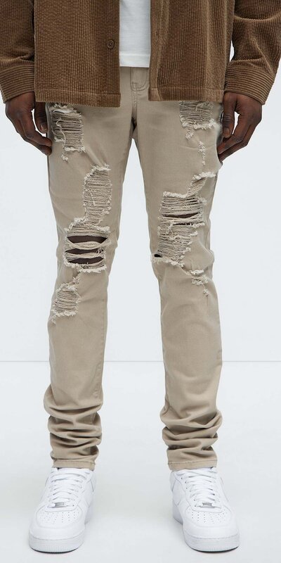 Béžové pánske skinny rifle s výrazným trhaným efektom Béžová