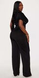 Čierny overal s nariaseným detailom a širokými nohavicami