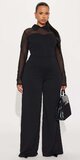 Čierny overal s dlhými rukávmi a širokými nohavicami