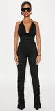 Elegantný overal s vrstvenými nohavicami v čiernej farbe