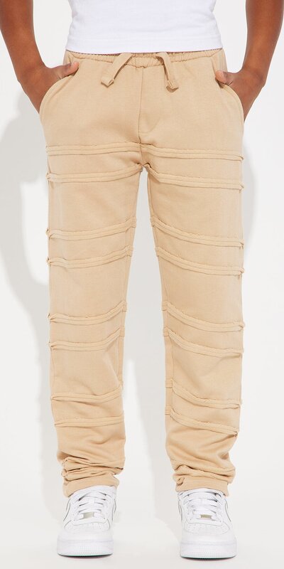 Teplákové nohavice s rovným strihom a strapkaným detailom v béžovej farbe